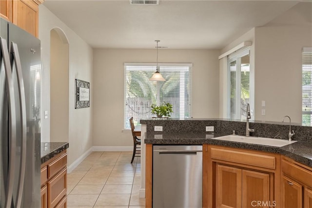 2327 Via Calle Ct, Durham, CA 95938 - kitchen with light tile patterned flooring, a sink, stainless steel appliances, decorative light fixtures, and baseboards