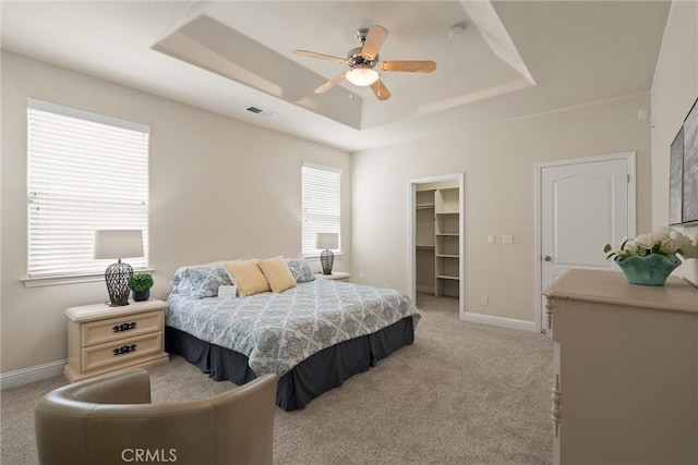 2327 Via Calle Ct, Durham, CA 95938 - bedroom featuring a raised ceiling, visible vents, a walk in closet, baseboards, and light colored carpet