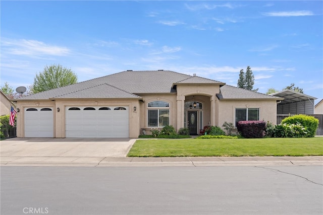 2327 Via Calle Ct, Durham, CA 95938 - ranch-style house featuring a garage, a front yard, driveway, and stucco siding