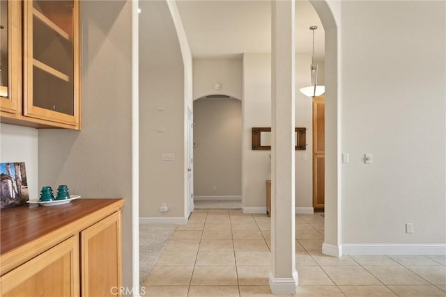 2327 Via Calle Ct, Durham, CA 95938 - hallway featuring light tile patterned floors, baseboards, and arched walkways