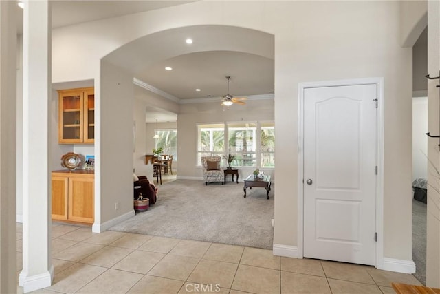 2327 Via Calle Ct, Durham, CA 95938 - foyer entrance with arched walkways, ornamental molding, ceiling fan, light tile patterned flooring, and light carpet