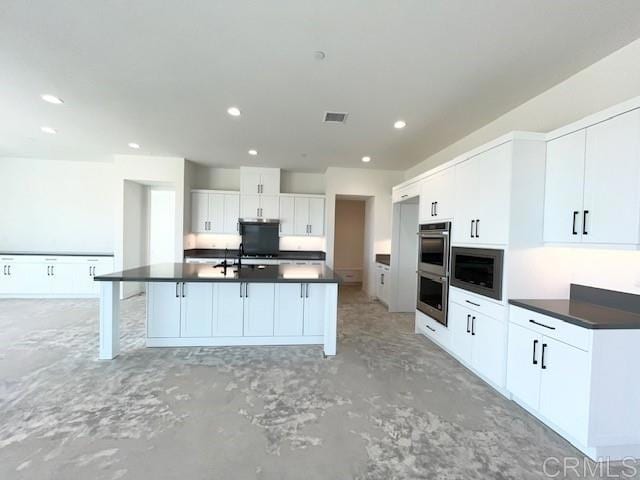 kitchen with visible vents, dark countertops, appliances with stainless steel finishes, recessed lighting, and white cabinetry