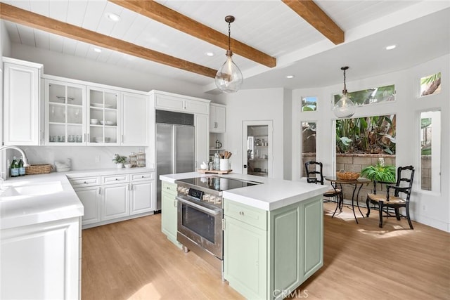 kitchen with white cabinetry, a sink, light wood-style flooring, green cabinets, and stainless steel appliances