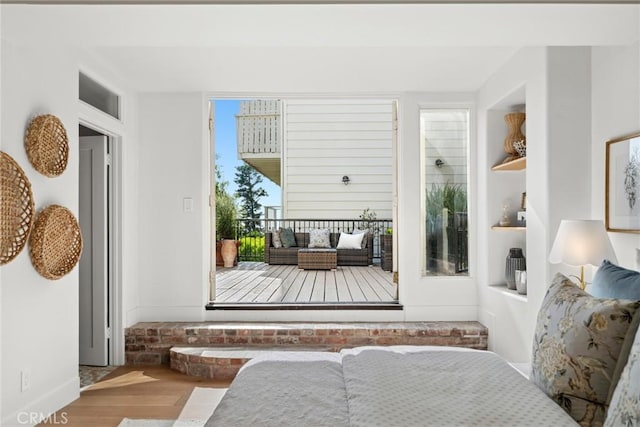interior space with baseboards and wood finished floors