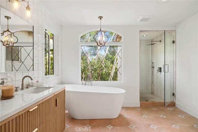 bathroom with baseboards, a chandelier, and a shower stall