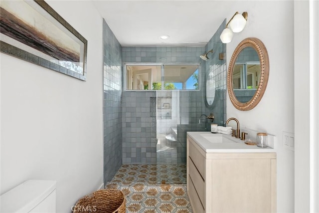 bathroom with vanity, walk in shower, tile patterned floors, and toilet