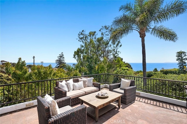 view of patio featuring a water view and an outdoor living space
