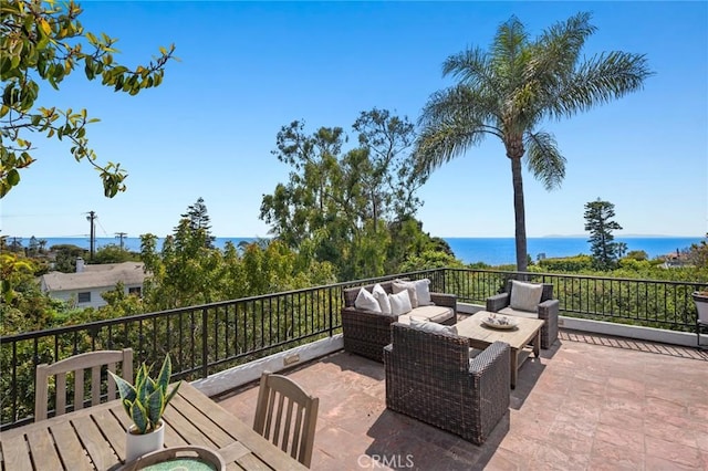 view of patio / terrace with an outdoor living space and a water view