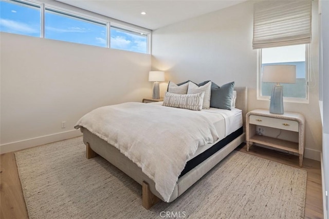 bedroom featuring baseboards, recessed lighting, and wood finished floors