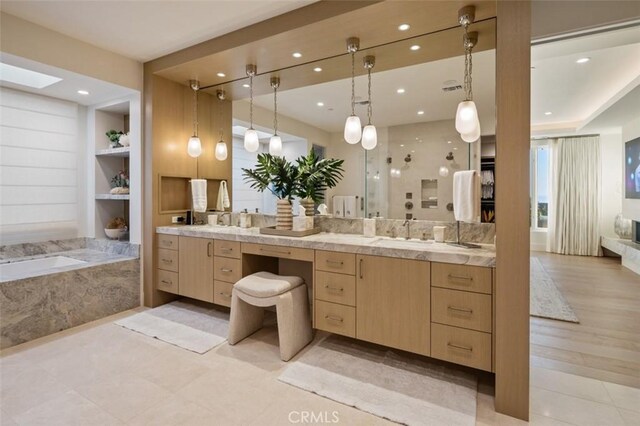 full bath with built in shelves, recessed lighting, vanity, tile patterned floors, and a garden tub