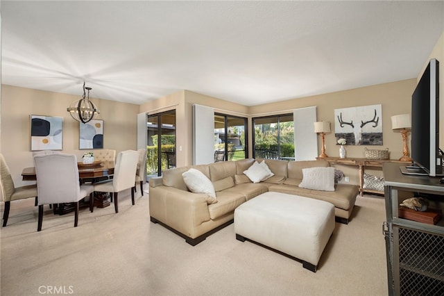 living area featuring an inviting chandelier and light colored carpet