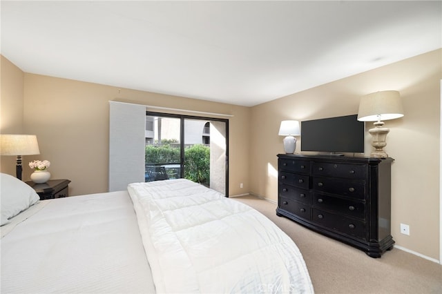 bedroom with light carpet and baseboards