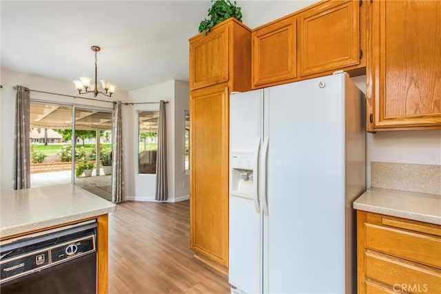 883 Riviera Ave, Banning, CA 92220 - kitchen with white refrigerator with ice dispenser, a chandelier, light countertops, light wood finished floors, and brown cabinets
