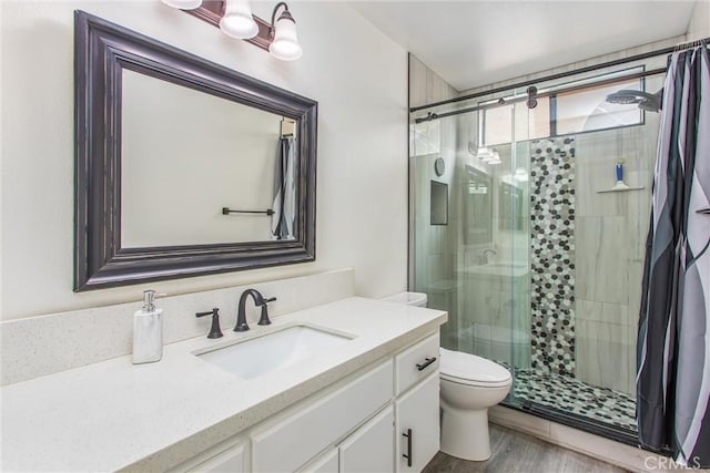 883 Riviera Ave, Banning, CA 92220 - full bath featuring a shower stall, toilet, vanity, and wood finished floors