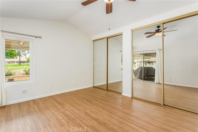 883 Riviera Ave, Banning, CA 92220 - unfurnished bedroom with two closets, light wood-style flooring, lofted ceiling, and a ceiling fan