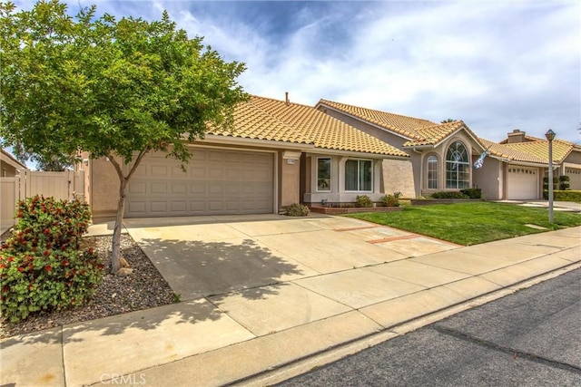 883 Riviera Ave, Banning, CA 92220 - view of front of home with an attached garage, stucco siding, driveway, and a tiled roof