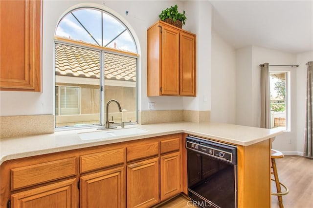 883 Riviera Ave, Banning, CA 92220 - kitchen with black dishwasher, a sink, plenty of natural light, and light countertops