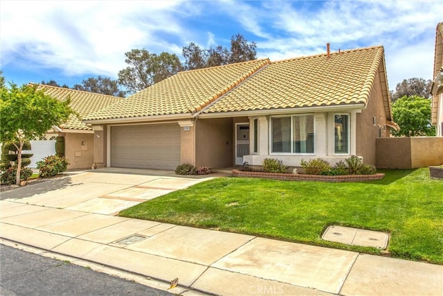 883 Riviera Ave, Banning, CA 92220 - view of front facade with a garage, stucco siding, a tiled roof, and concrete driveway