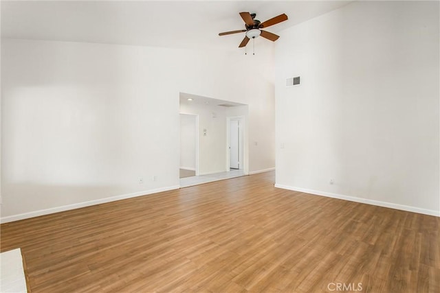 883 Riviera Ave, Banning, CA 92220 - empty room featuring a ceiling fan, light wood-style flooring, baseboards, and high vaulted ceiling
