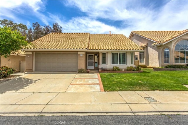 883 Riviera Ave, Banning, CA 92220 - view of front of house with an attached garage, concrete driveway, a front yard, and stucco siding