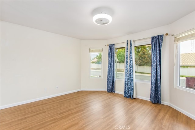 883 Riviera Ave, Banning, CA 92220 - empty room featuring light wood-style floors, plenty of natural light, and baseboards
