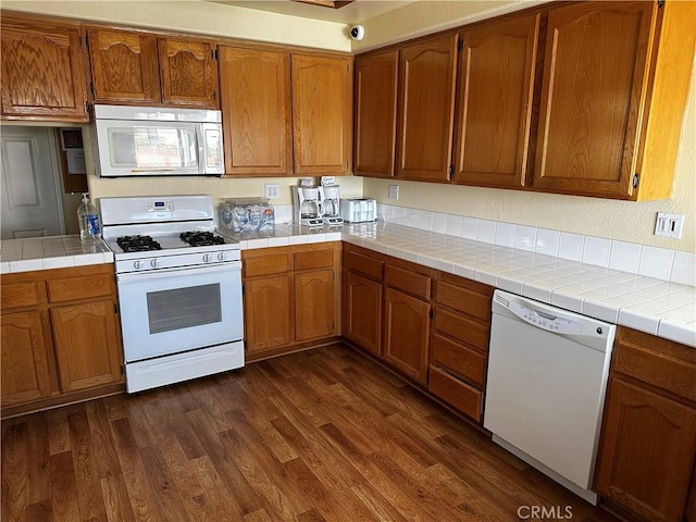 750 Diamante, San Jacinto, CA 92583 - kitchen with white appliances, dark wood-style floors, brown cabinets, and tile counters