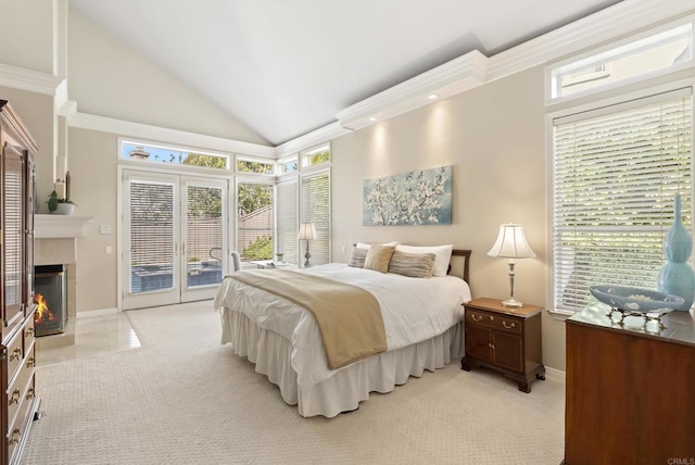 bedroom featuring access to outside, lofted ceiling, a fireplace with flush hearth, and baseboards