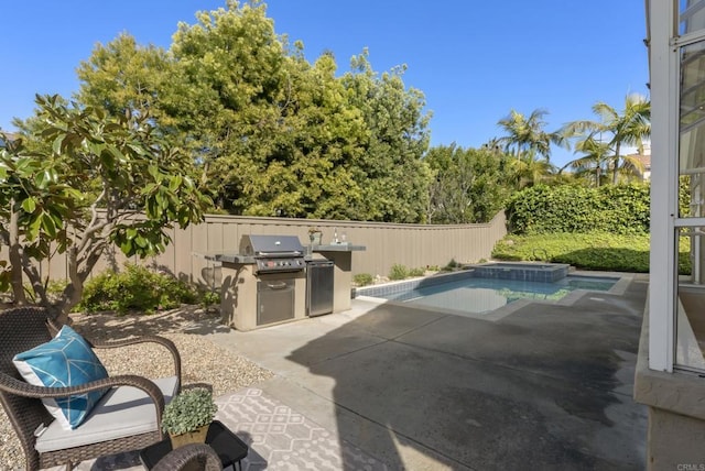 view of swimming pool with a fenced backyard, a patio, and a grill