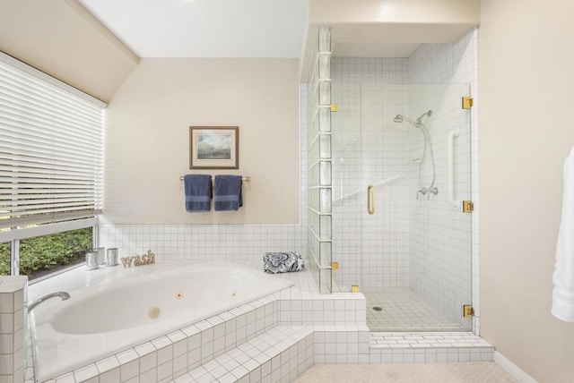 full bathroom with a shower stall and a jetted tub