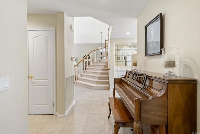 hall with stairway, light tile patterned flooring, baseboards, and recessed lighting
