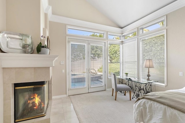 tiled bedroom with french doors, access to outside, vaulted ceiling, and a tiled fireplace