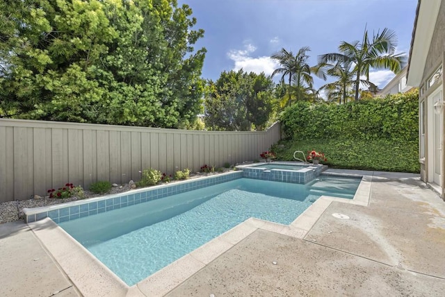 view of pool featuring a fenced backyard, a patio, and a pool with connected hot tub
