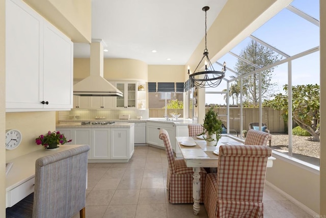 dining space featuring light tile patterned floors, a chandelier, and recessed lighting