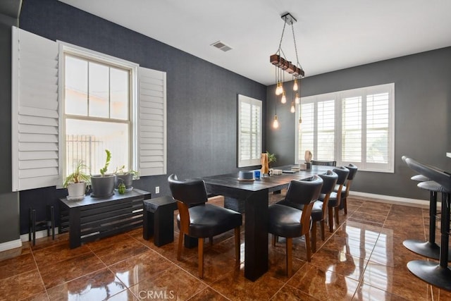 dining room featuring visible vents and baseboards