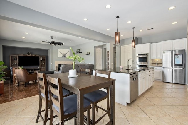kitchen featuring recessed lighting, light tile patterned floors, appliances with stainless steel finishes, and a sink