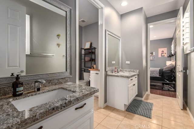 16550 Catalonia Dr, Riverside, CA 92504 - full bath with toilet, two vanities, tile patterned flooring, ensuite bath, and recessed lighting