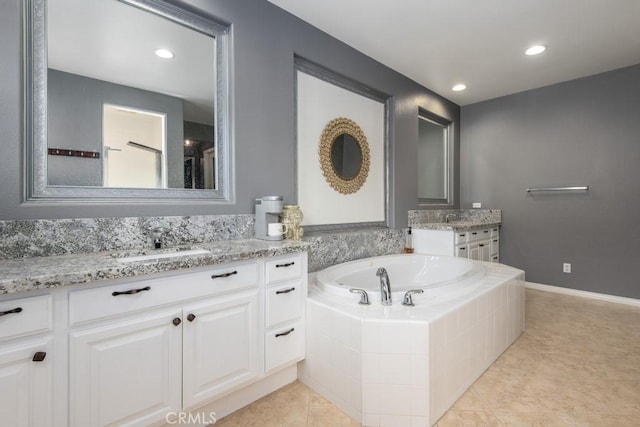 bathroom with recessed lighting, tile patterned floors, two vanities, a sink, and a garden tub