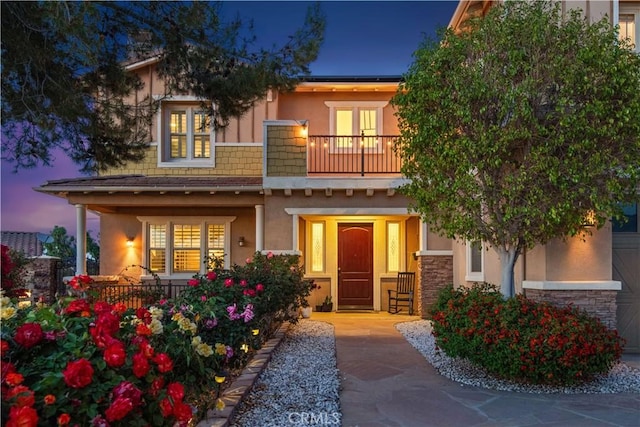 16550 Catalonia Dr, Riverside, CA 92504 - view of front of property with a balcony, covered porch, stucco siding, and stone siding
