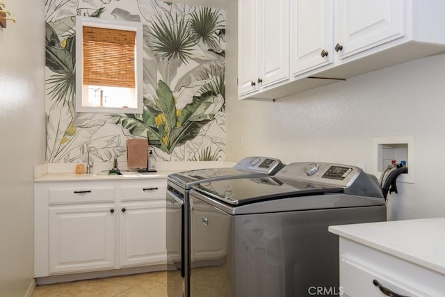 16550 Catalonia Dr, Riverside, CA 92504 - laundry area featuring washing machine and clothes dryer, cabinet space, and light tile patterned flooring