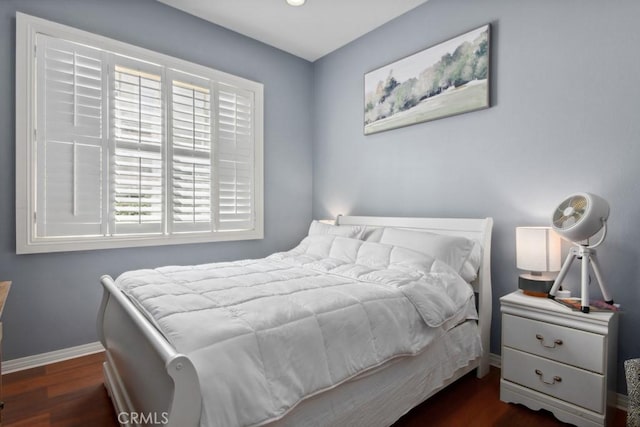 bedroom with baseboards, recessed lighting, and dark wood-type flooring