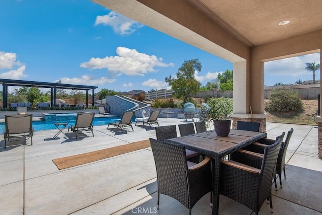 view of patio / terrace with outdoor dining area, an outdoor pool, and a fenced backyard