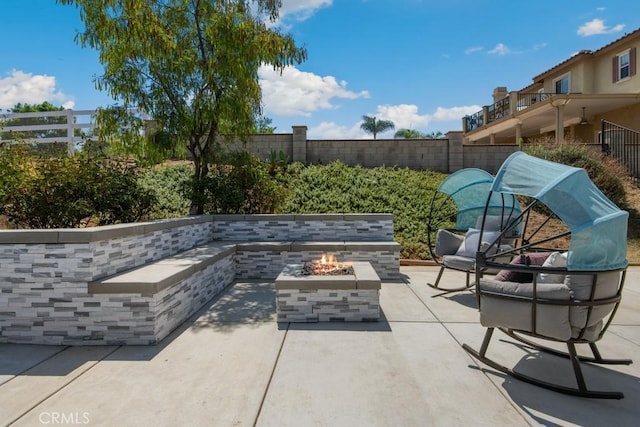 view of patio with a fire pit and a fenced backyard