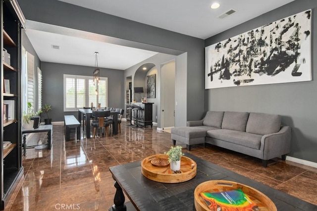 16550 Catalonia Dr, Riverside, CA 92504 - living room featuring baseboards and arched walkways
