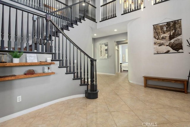 16550 Catalonia Dr, Riverside, CA 92504 - stairs featuring tile patterned flooring, a towering ceiling, and baseboards