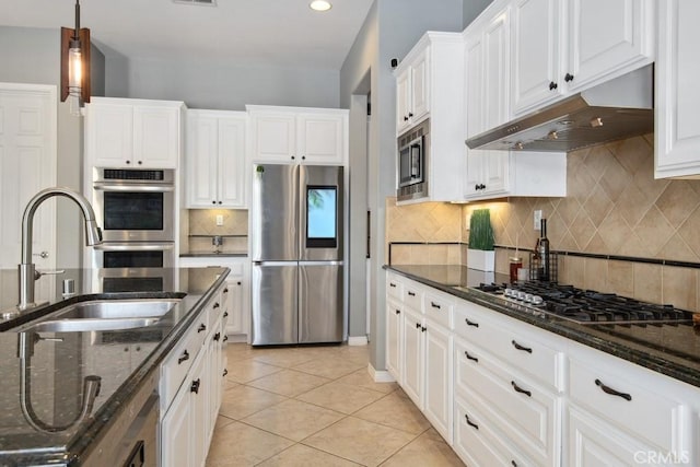 kitchen with a sink, stainless steel appliances, white cabinets, and under cabinet range hood
