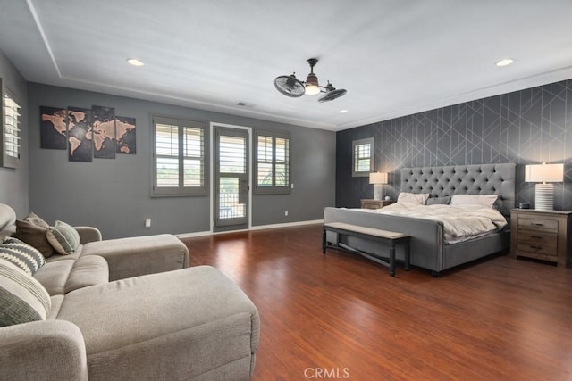 bedroom featuring recessed lighting, visible vents, baseboards, an accent wall, and wood finished floors