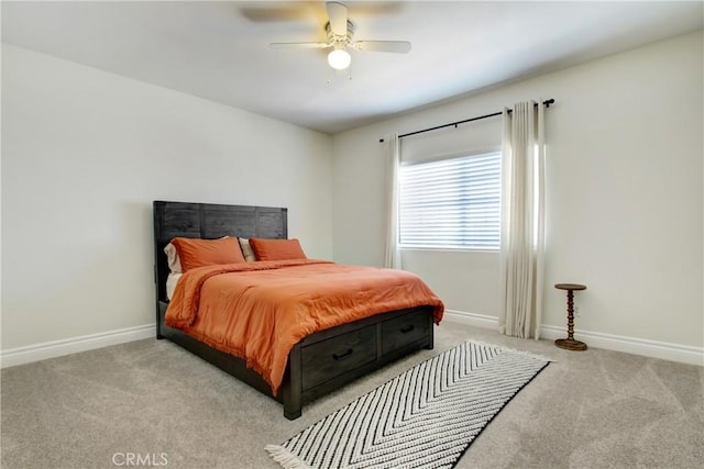 carpeted bedroom with a ceiling fan and baseboards