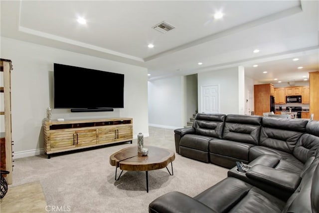living area with recessed lighting, light carpet, baseboards, visible vents, and a raised ceiling