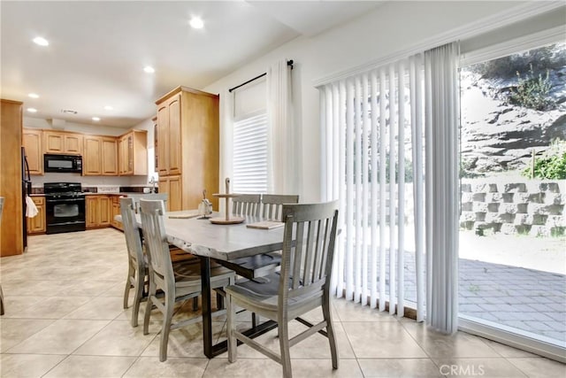 dining room with recessed lighting, light tile patterned flooring, and a wealth of natural light