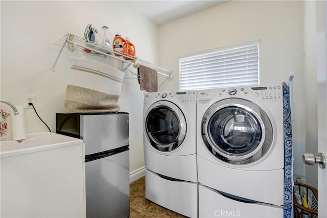 washroom with separate washer and dryer and laundry area